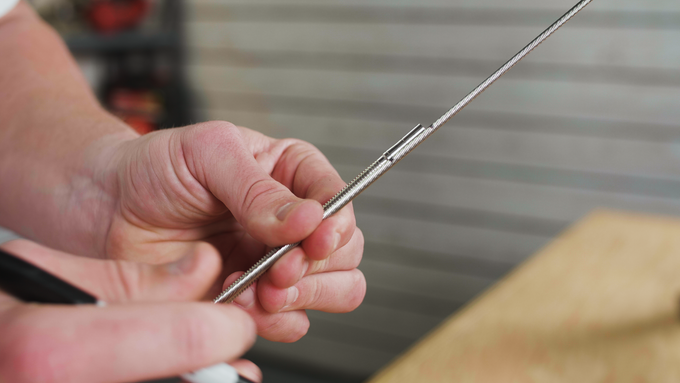 Thru-Post-Tensioners-in-Metal-Posts-use-stud-to-mark-cut-length-close-up Thru-Post-Tensioners-in-Metal-Posts-use-stud-to-mark-cut-length-close-up