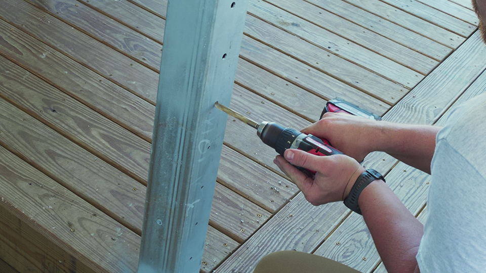 drilling-holes-metal-posts-cable-railing