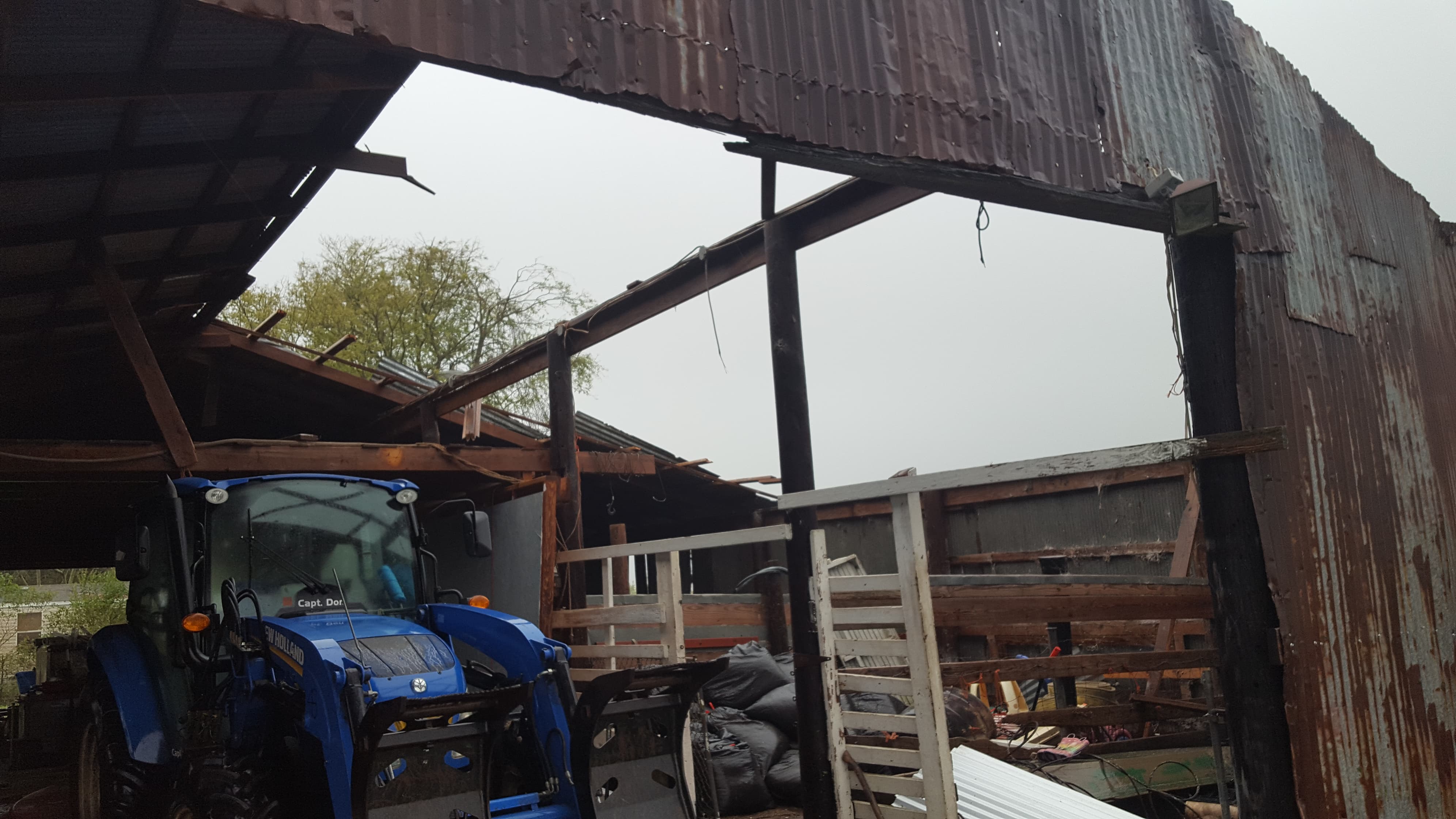 Tractor in shed with debris